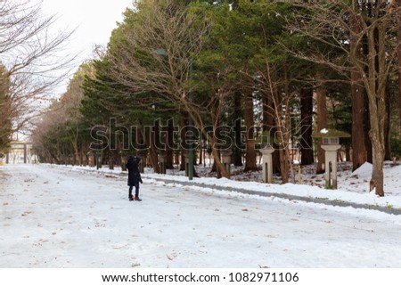 Man taking picture of the  Beautiful Winter landscape with road covered by snow,