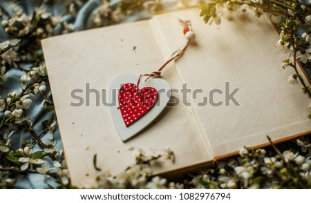 White heart. Paper card in form of heart. Spring fruit trees white flowers photo. Natural wooden background with white flowers fruit trees and space for text