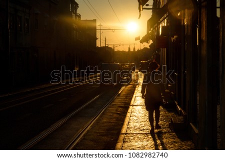 Woman on street at sunset