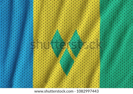Saint Vincent and the Grenadines flag printed on a polyester nylon sportswear mesh fabric with some folds