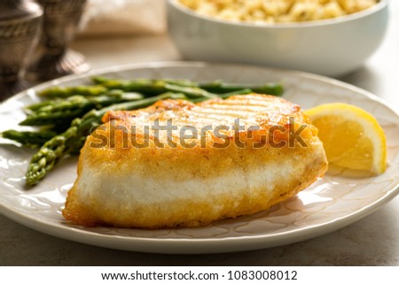 Delicious pan seared halibut with asparagus and wild rice.