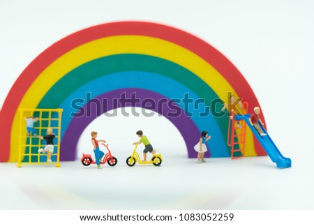Miniature people: Group of children playing on white background with copy space using as education, boy and girl, children's day concept.