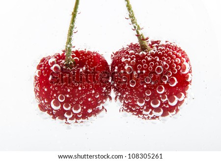 cherries in water with bubbles