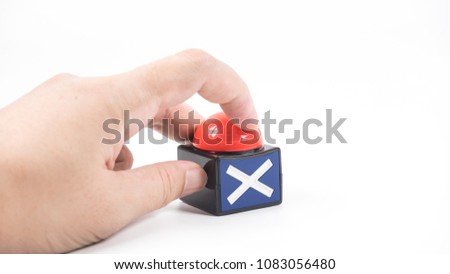 Hand holding voting buzzer button. Concept of election or elimination. Isolated on white background. Slightly defocused and close-up shot. Copy space.