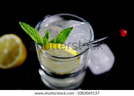 Vodka soda close up with yellow lemon slice.