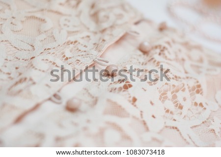 Fragment detail of lace women dress with buttons. Fashion texture.