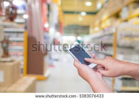 blurred photo smartphone on supermarket store on background with bokeh