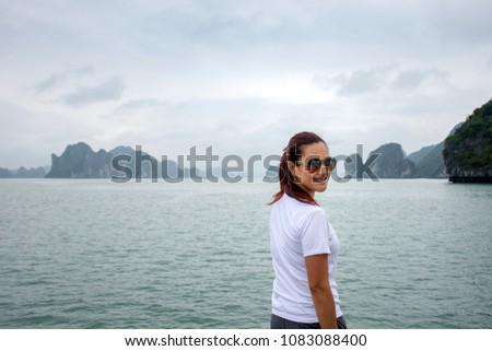 Picture of attractive Asian women looking at camera with beautiful landscape island and sea in the morning