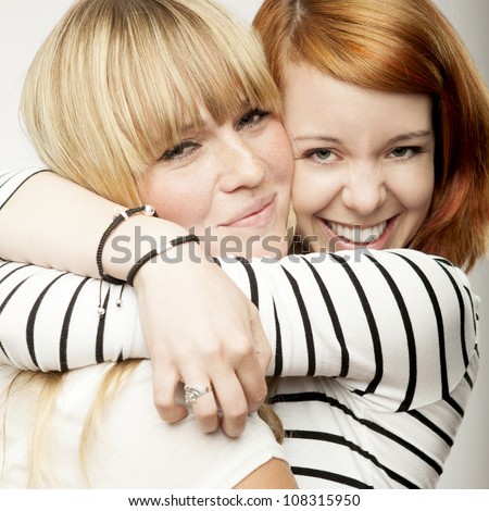 red and blond haired girls friends laughing and hug Royalty-Free Stock Photo #108315950