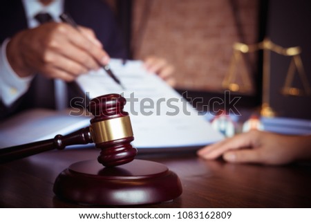 Partner lawyers or attorneys discussing a contract agreement. Successful businessmen hand putting signing contract,have a contract in place to protect it,signing of modest agreements form in office.