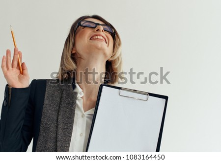 woman with glasses looks up, document, pencil                            