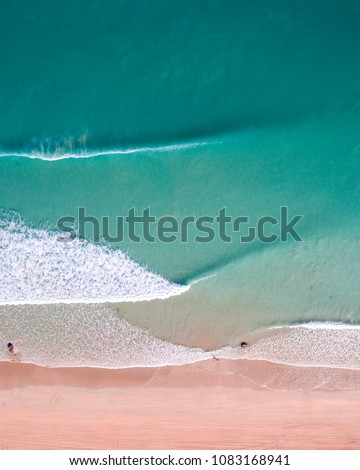 An aerial view of waves crashing on Cable Beach in Broome, Western Australia.  Royalty-Free Stock Photo #1083168941