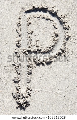 The letter P of the alphabet writing on the sand beach