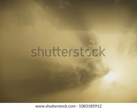 Glowing sun hide and seek behind clods on a sunny day, sun facing at camera morning day time photo with sun rays beam