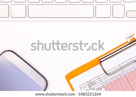 a computer keyboard, a patient vital sign chart, and a smartphone on a white table background, doctor working space concept