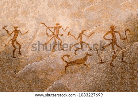 image of ancient hunters with a dog on the wall of the cave. ancient art, history, archeology Royalty-Free Stock Photo #1083227699