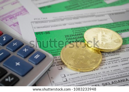 Polish tax form PIT-36 for individual tax return. Translation from Polish: Testimony about an income/suffered losses in the fiscal year. Calculator and bitcoin pile as cryptocurrency concept