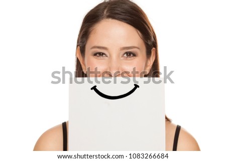 happy and smiling girl with a smile painted on paper