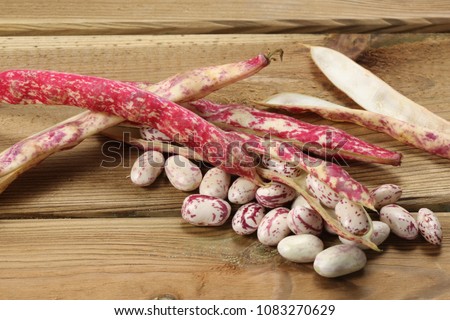fresh raw beans on a wooden table