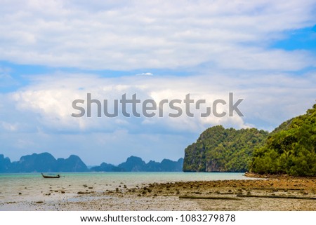 Low tide in the famous Phang Nga Bay - mudflat with a fishing boat, Thailand, 2018