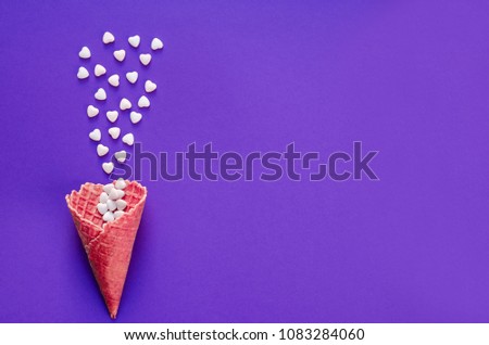 Ice Cream Cone Horn Hearts Sweethearts Candies. Flat lay Top View. Love,Valentines day concept. Summer Party, Birthday Firework Ultra Violet background. Bright Sweet Color. TrendyStyle. 