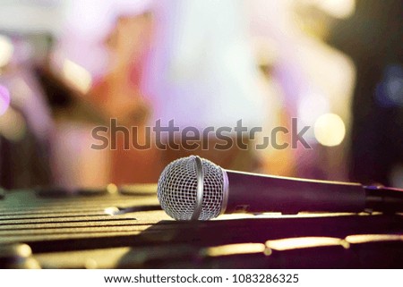 Closeup microphone on black table in a party and blurry background. 