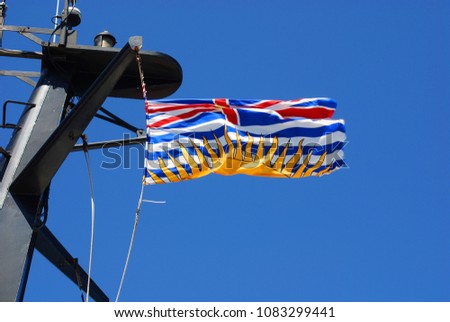 British Columbia Canadian provincial flag that is horizontally divided, bearing Union Jack emblem in its upper and wavy stripes of white and blue and a stylized portion of the sun in its lower half.