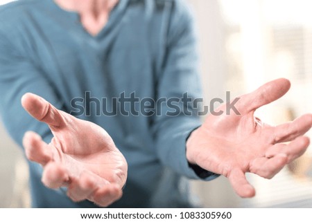 Hands of man in gesture of support, selective focus