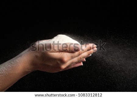 Flour in hands blowing