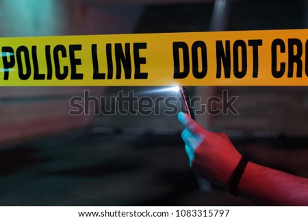 curious onlooker taking picture with smartphone the crime scene at night Royalty-Free Stock Photo #1083315797