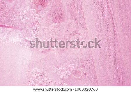 Pink background of fabric with a pattern. Fatine with a picture and decoration. Veil of the bride closeup