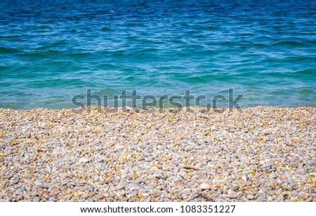Colorfil, bright beach with sea stones and blue sea