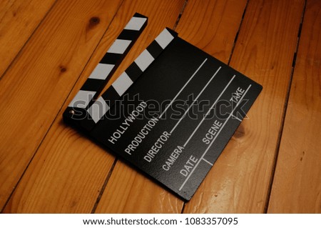 Production slate clapboard close up on wooden background
