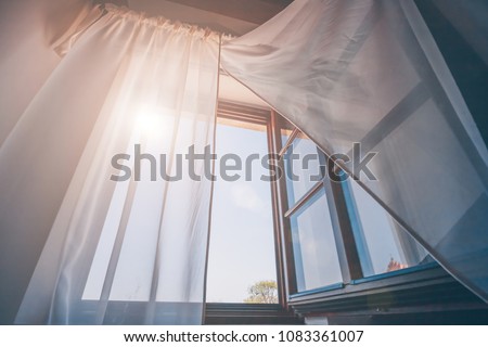 Bright morning sun in the open window through the curtains Royalty-Free Stock Photo #1083361007