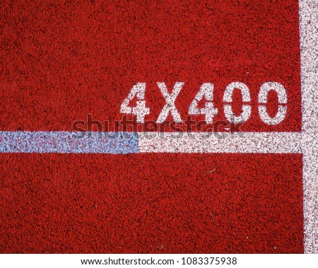 Sign in the lane of red running track on natural light on top view. 4x400m relay race.
