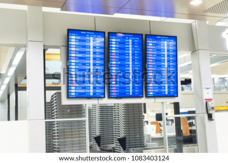 blurry image of flight schedule board for background.