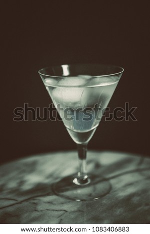 cold drink in martini glass with black background