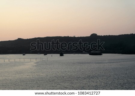 sunset over a plain surface of water of the flat river
