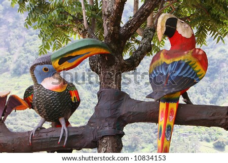 Wooden Toucan and Macaw in an artificial tree in Banos Ecuador