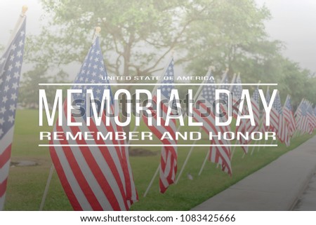 Text Memorial Day remember and honor on long row of lawn American Flags background. Green grass yard USA flags blow in the wind. Concept of Memorial day or Veteran's day in America.