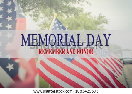 Text Memorial Day and honor on long row of lawn American Flags background. Green grass yard USA flags blow in the wind. Concept of Memorial day or Veteran's day in America.