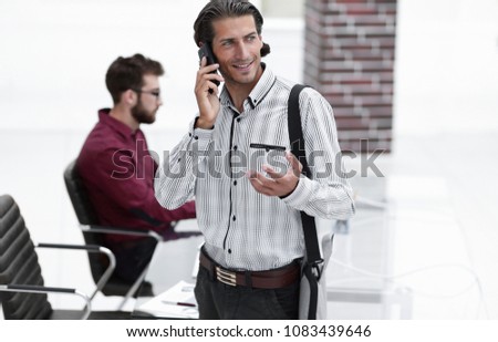 man talking on smartphone in office