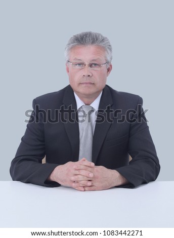 Gray-haired business man smiling isolated on gray background.