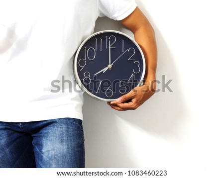Man white shirt with jean hold the analog clock silver needle in left hand at white isolated background