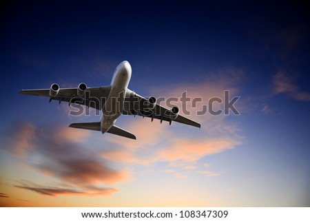 Airbus A380 jet aeroplane taking off in  bright dramatic twilight sunset moody sky. Royalty-Free Stock Photo #108347309