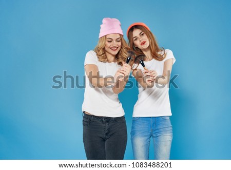 cheerful girlfriend, blue background, fashion                        