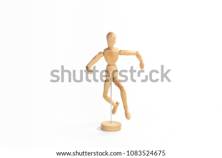 A wood figure model in runaway action with white background.