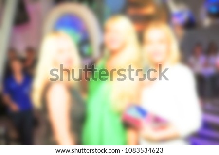 blurred for background night club party. People smiling and posing on cam during concert in night club party. Man and woman have fun at club. Boy and girl at night club party