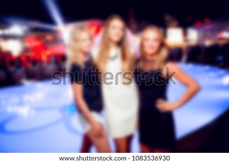 blurred for background night club. People smiling and posing on cam during concert in night club party. Man and woman have fun at club. Boy and girl at night club party