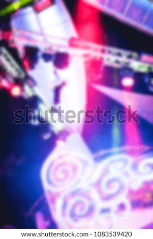 blurred for background Night club dj party people enjoy of music dancing sound with colorful light with Smoke Machine and lights show. Hands up in the earth.